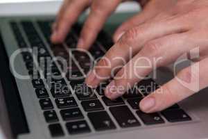 Close up of businessman typing on laptop computer