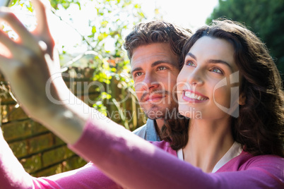 Smiling couple standing together in garden