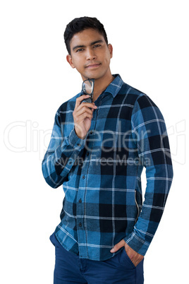 Portrait of smiling young man holding eyeglasses