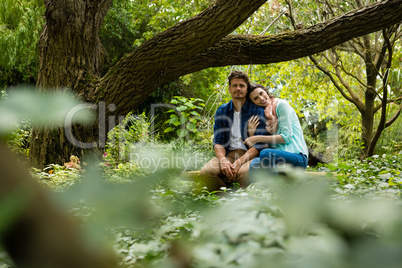 Romantic couple sitting on bench in garden
