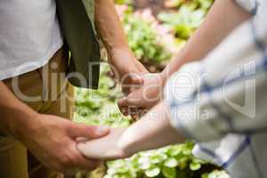 Mid-section of couple holding hands