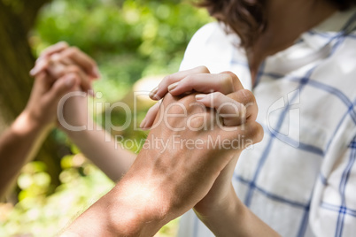 Mid-section of couple holding hands