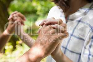 Mid-section of couple holding hands