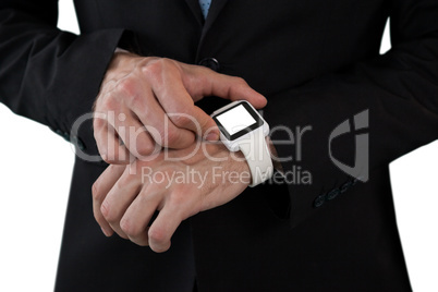 Mid section of businessman using smart watch