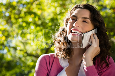 Woman sitting on bench and talking on mobile phone