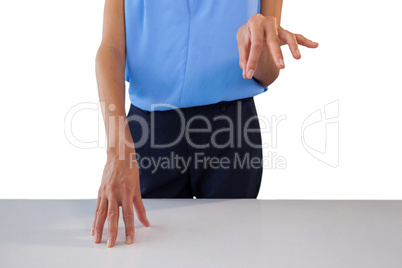 Mid section of businesswoman holding something at table