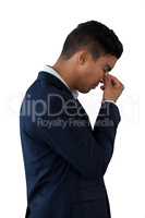 Side view of businessman with head in hand suffering from headache