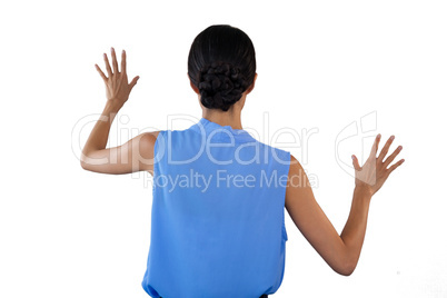 Businesswoman in sleeveless clothing touching interface
