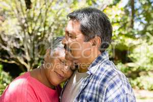 Senior couple embracing each other in garden