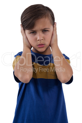 Cute boy covering his ears against white background