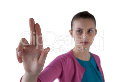 Teenage girl pressing an invisible virtual screen