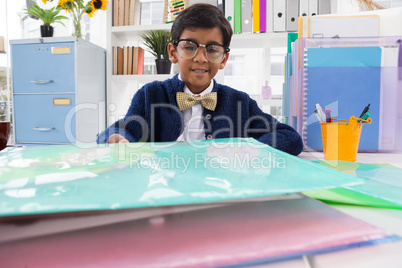 Portrait of smiling businessman wearing eyeglasses working at desk