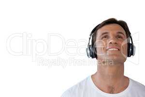 Happy mature man wearing headphones looking up