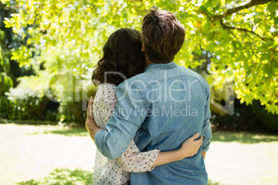 Couple embracing each other in garden on a sunny day Couple embracing each other in garden on a sunny day