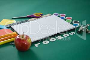 School supplies with text arranged on green background