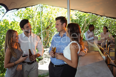 Friends having a alcohol at counter