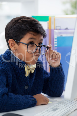 Businessman making face while looking at computer monitor