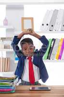 Boy imitating as businessman stretching while looking away