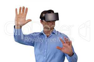 Smiling businessman gesturing while wearing vr glasses