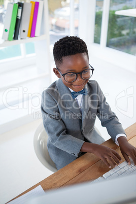 High angle view of smiling businessman using computer