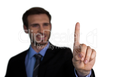 Close up of smiling businessman touching index finger on invisible interface