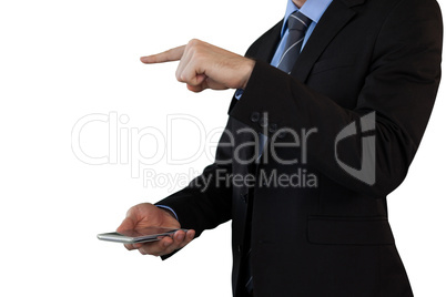 Mid section of businessman in suit gesturing over smart phone