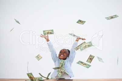 Happy businesswoman with arms raised throwing paper currency