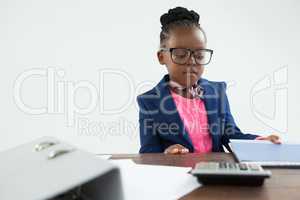 Serious businesswoman looking at files in office