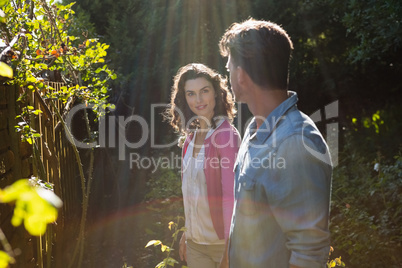 Smiling couple looking face to face in garden