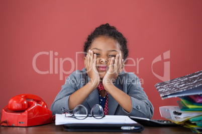 Portrait of bored businesswoman with hand on chin