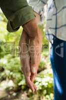 Mid-section of couple holding hands