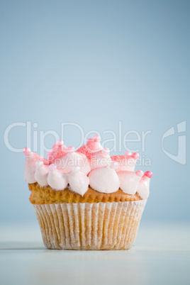 Close-up of pink cupcake on table