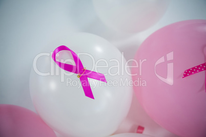 High angle view of pink Breast Cancer ribbons on balloons