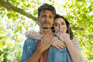 Couple embracing each other in garden on a sunny day