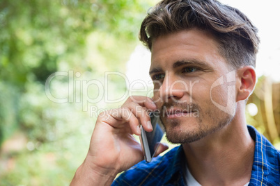 Man talking on mobile phone in garden