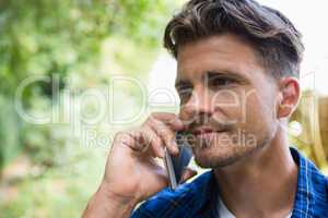 Man talking on mobile phone in garden