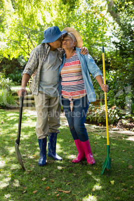 Senior couple kissing each other in garden