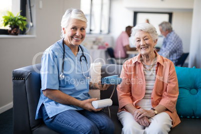 Portrait of senior woman with female doctor