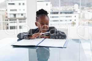 Thoughtful businesswoman with document looking away at table