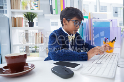 Businessman typing while working in office