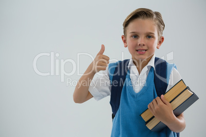 Portrait of school boy showing thumbs up