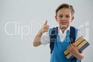 Portrait of school boy showing thumbs up