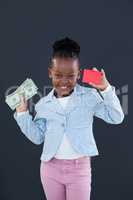 Portrait of businesswoman holding red card and paper currency