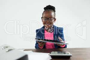 Smiling businesswoman wearing eyeglasses holding file