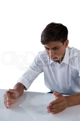 Teenage boy pretending to work on an invisible object