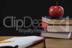 Apple and book on wooden table