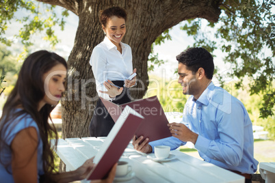 Waitress writing order on notepad