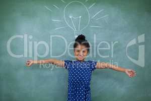 Portrait of girl with arms outstretched by bulb drawing on wall