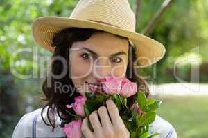 Portrait of woman holding flowers in garden