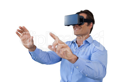 Happy businessman gesturing while wearing virtual reality simulator